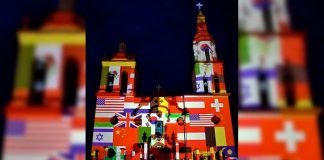 Iluminan iglesia de Santiago con banderas de países afectados por coronavirus